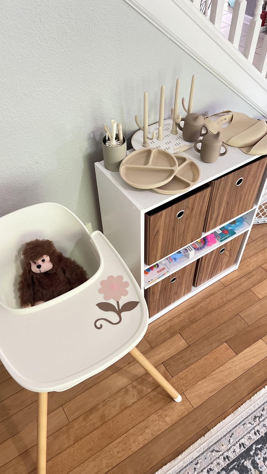 Feeding station with a high chair, drying rack, and stacked silicone plates